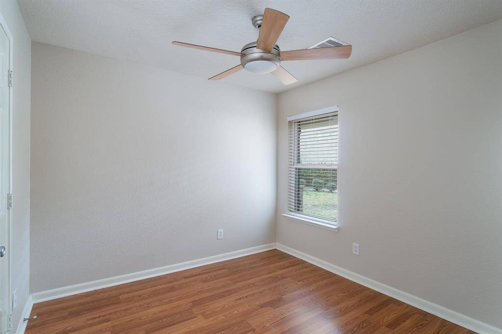 Bedroom 2 w/ laminate floors, ceiling fan and generous size closet.