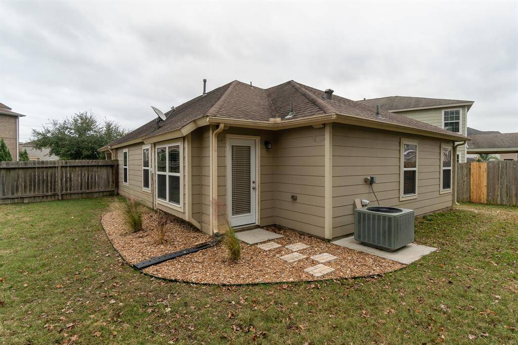 Fully fenced backyard w/ tasteful landscaping.
