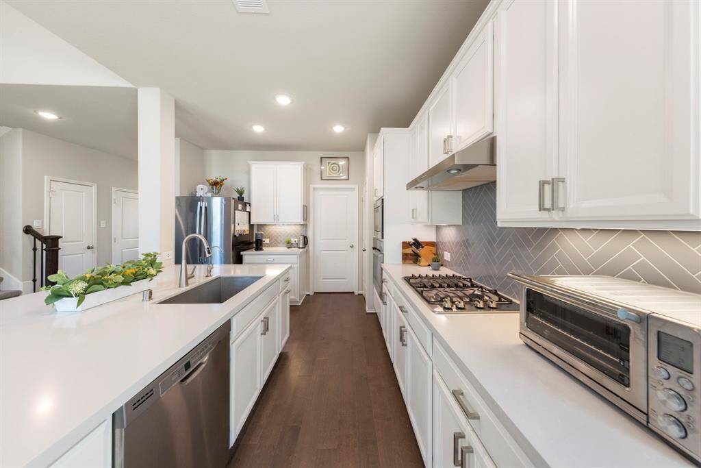 Stainless steel appliances, including a gas range.