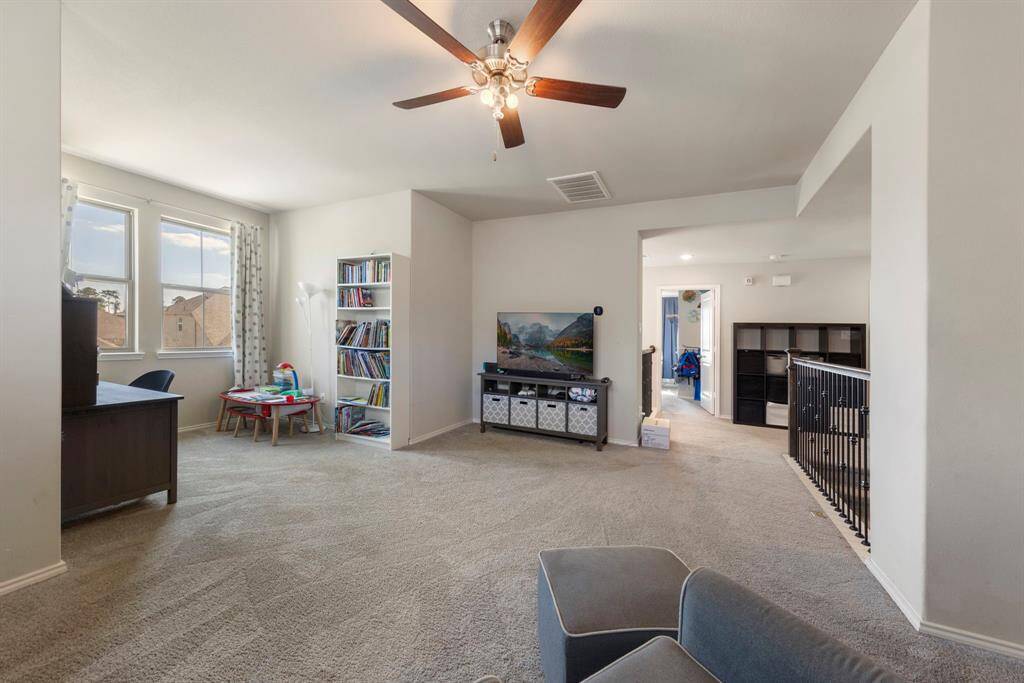 Upstairs, an expansive and versatile game room awaits.