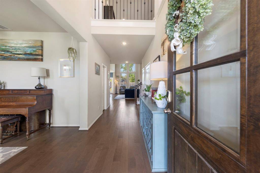 Enter to find impressive ceilings, warm wood flooring, and sun-drenched living spaces throughout.