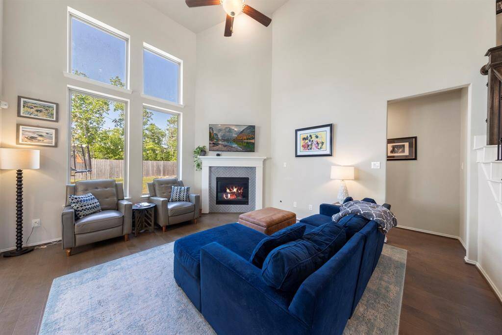 Be wowed by the grand family room, featuring a cozy gas log fireplace as its centerpiece and expansive views of the outdoors.