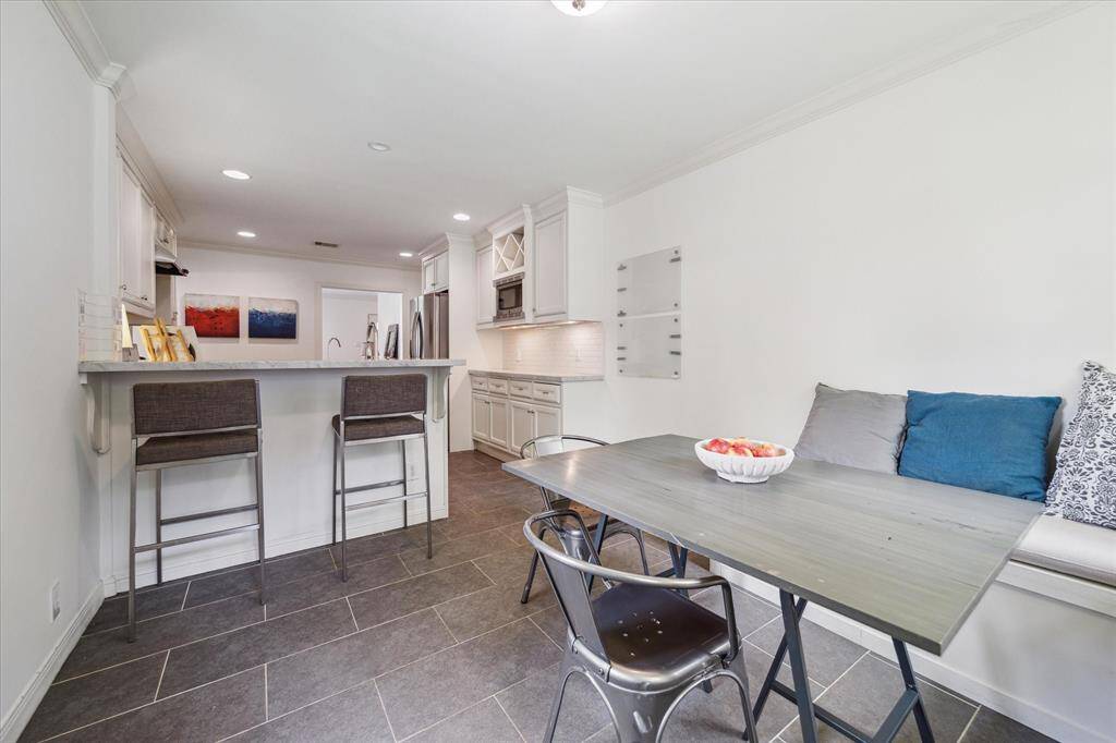 Updated kitchen includes an eat in breakfast area and bar