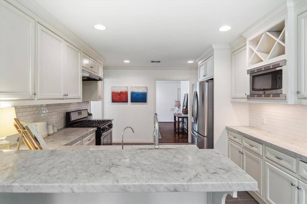A view of the kitchen bar area looking into living area.