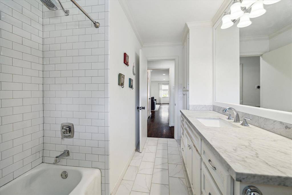 Hall bathroom located between the 2 secondary bedrooms has been recently updated with nice neutral tile and countertop