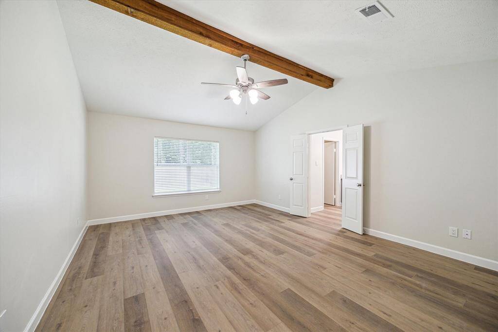 Large primary bedroom with vaulted ceiling