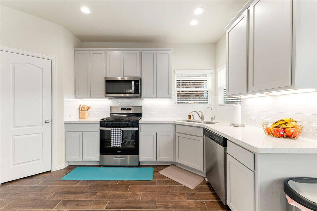 Any chef's dream, this stunning kitchen is perfect for everyday life as well as entertaining family and friends! Ample counter space and plenty of cabinetry for all your needs. Large windows provide lovely views of your backyard and plenty of natural lighting throughout the day.