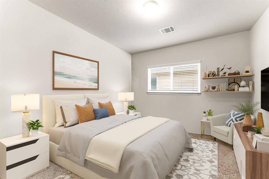 Secondary bedroom great for use as an in-law suite or guest suite features high ceilings, custom paint, plush carpet, space for seating area, direct access to the secondary bathroom and large window with privacy blinds. *Virtually Staged