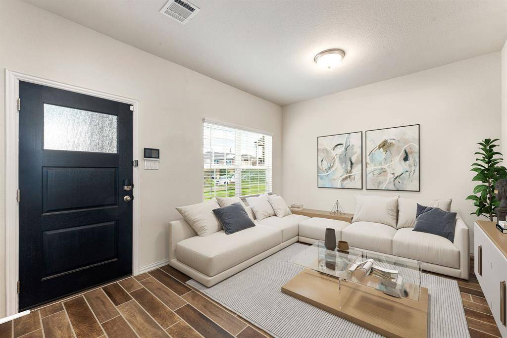 Welcome to your future home! This inviting entryway opens into a bright and versatile sitting room, perfect as a cozy lounge, stylish home office, or playroom. Let your imagination make this space your own! *Virtually Staged
