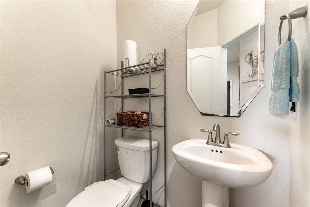 Conveniently located on the main floor, this stylish half bath offers modern fixtures and a clean design, perfect for guests and everyday use.