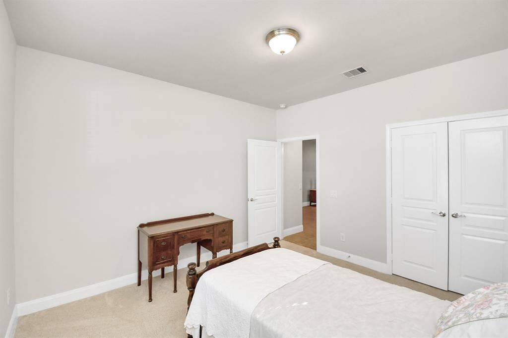 The front bedroom offers plenty of space and double-door closet for ample storage
