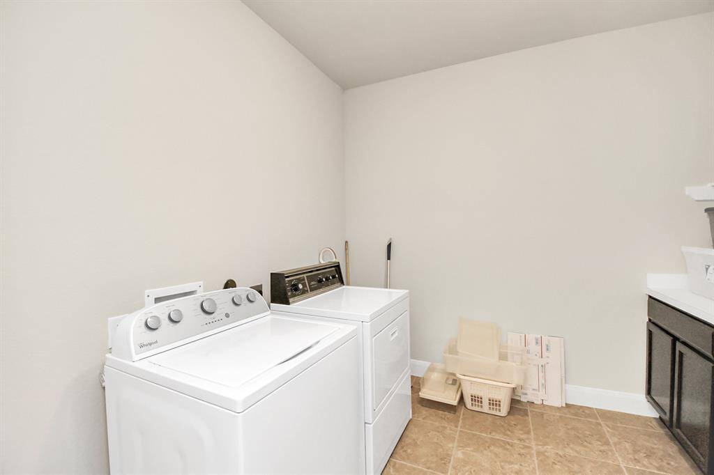 The laundry features storage and folding station.