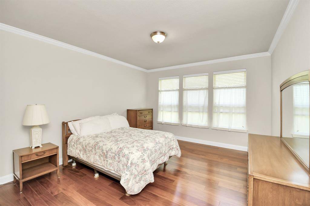 The Primary offers plenty of natural light that enhances the beautiful flooring.