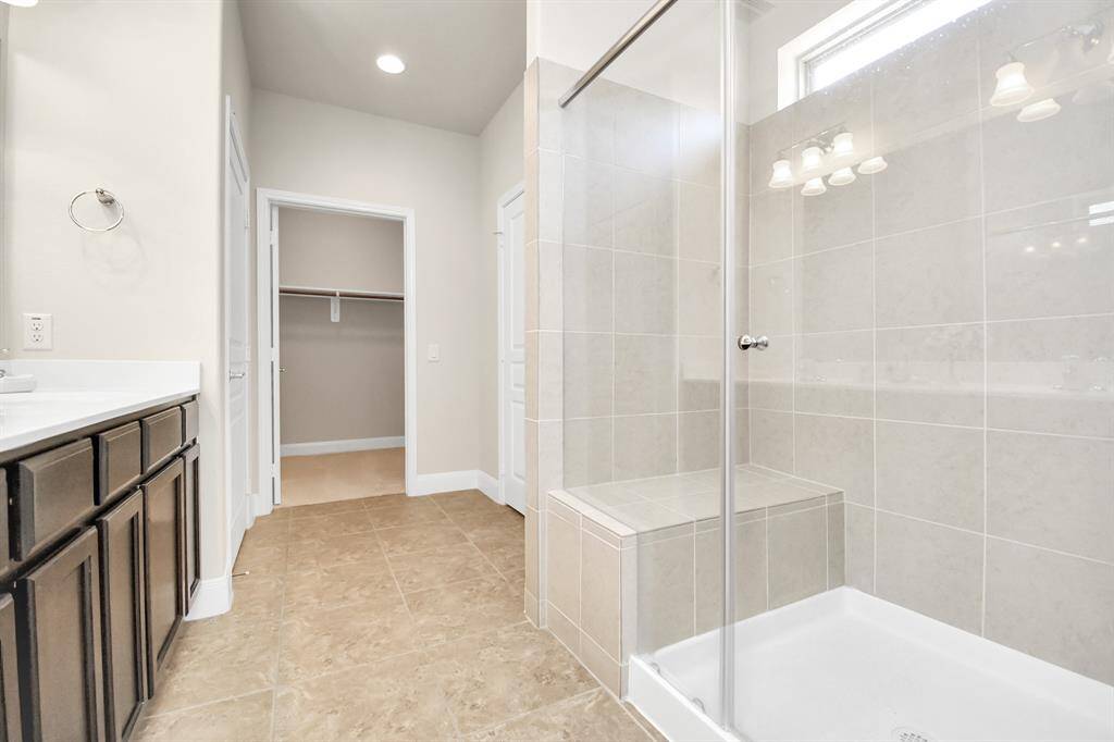 Thoughtfully designed with a bench in the Primary shower, it allows for an expanded linen closet adding to the storage in this home.