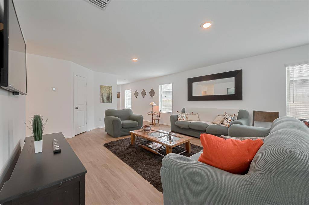 Spacious family room filled with natural light — perfect for relaxing or entertaining