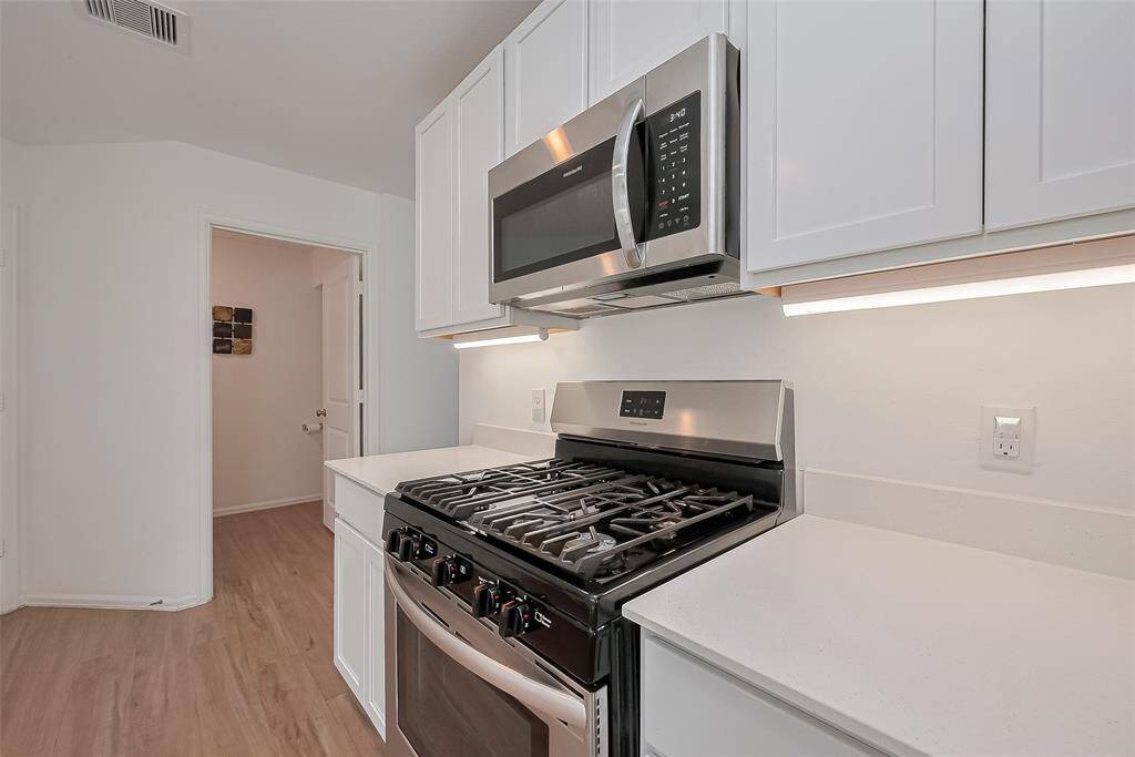 Modern kitchen equipped with elegant quartz countertops and stainless steel appliances — the perfect blend of style and modern look.
