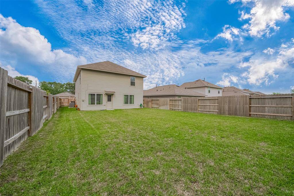 Backyard equipped with a sprinkler system for easy lawn maintenance.