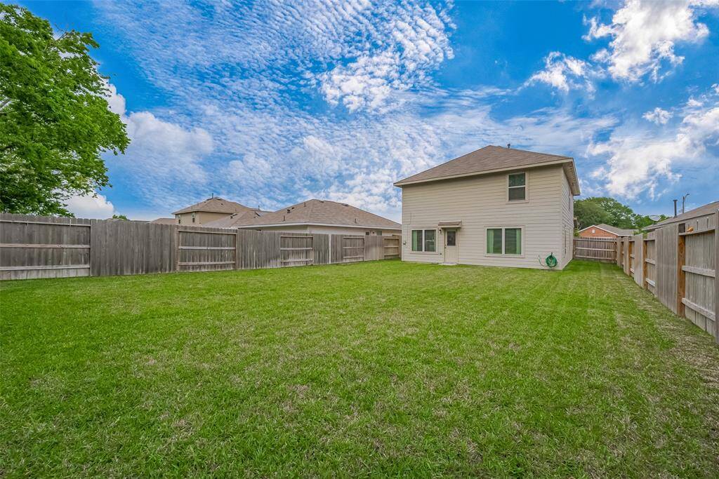 Backyard equipped with a sprinkler system for easy lawn maintenance.