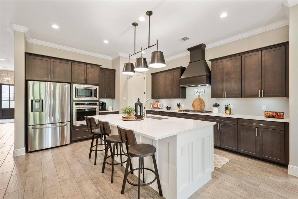The Kitchen Island provides additional seating thanks to the countertop overhang. This oversized island is the perfect place to decorate cookies, display holiday dinners, and grab a quick breakfast before heading out for the day.
