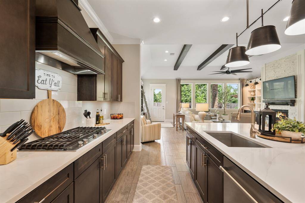 Equipped with KitchenAid appliances, including a 5-burner gas cooktop, built-in oven and microwave, and whisper quiet dishwasher, the family chef will feel right at home in the comfort of this high-end, spacious, gourmet Kitchen!