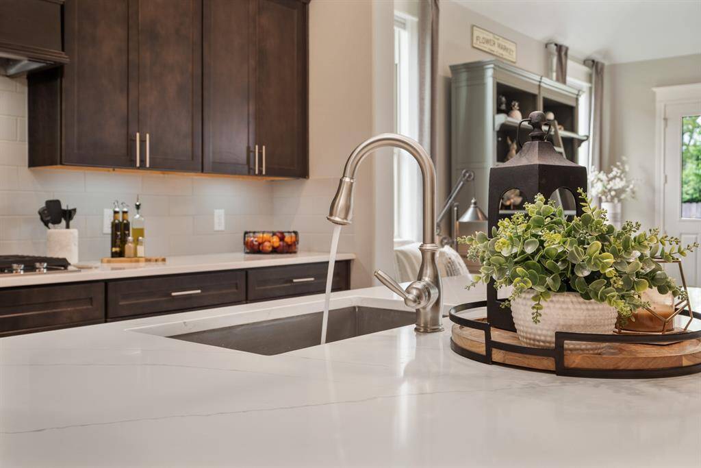 A stainless steel, single basin, undermount sink is centrally fixed in the Kitchen Island and boasts a pull-down faucet. Cleanup will be a breeze no matter how many pots, pans, and utensils were used when preparing dinner!