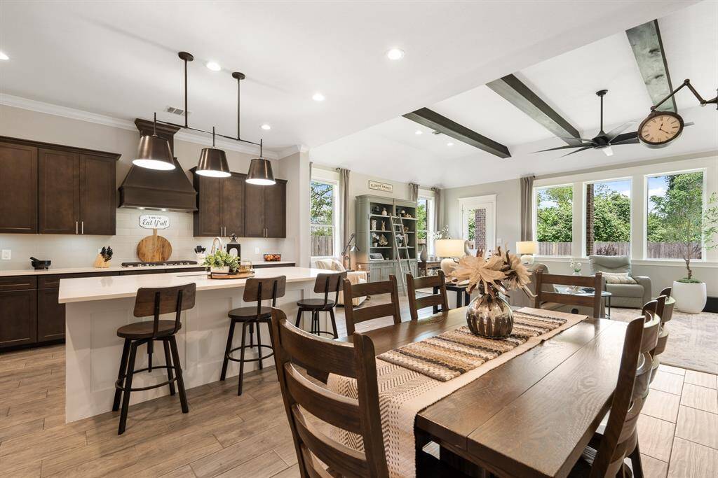 The Breakfast Room is centrally positioned in the main living space, with open sightlines to both the Kitchen and Living Room. This area remains light and bright thanks to the natural light that spills in from the front door ahead, recessed lighting above, and the windows towards the back.