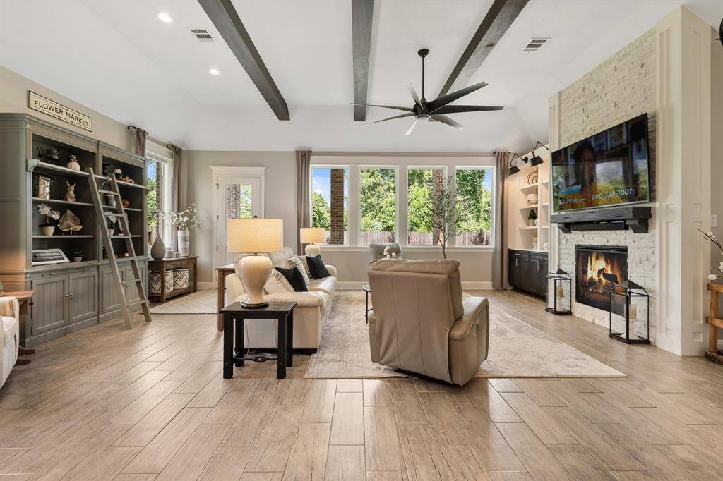 This stylish Living Room will invite you to sit back and relax after a long day. The quartet of fully cased picture windows welcomes an abundance of natural light to the space, aiding in a light and airy feel throughout.