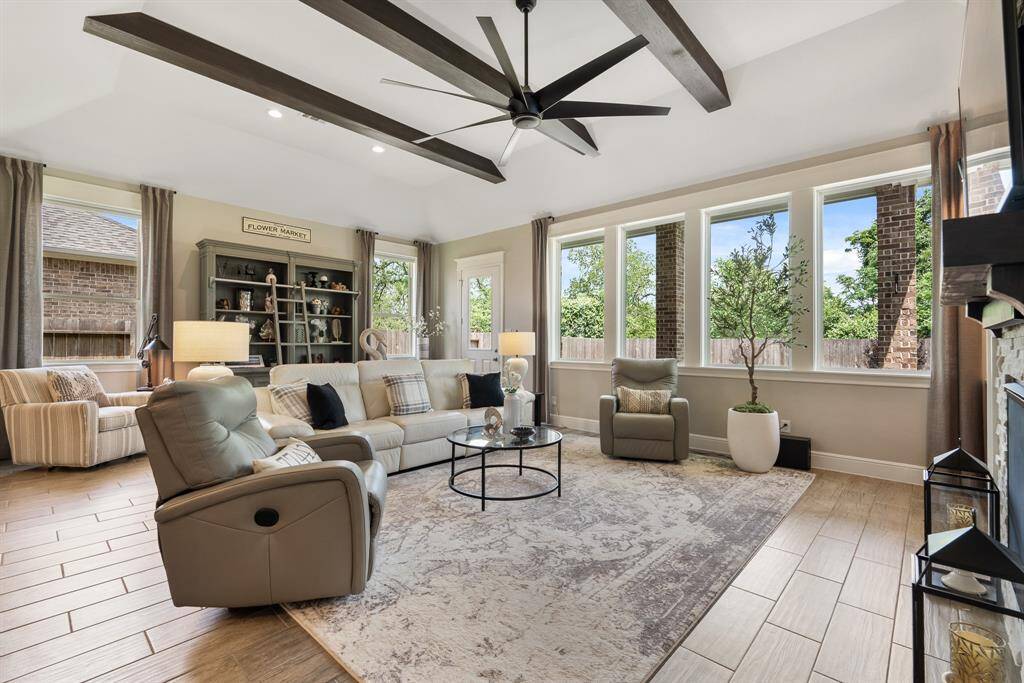 This angle provides a great look at the wood beams stretching the entirety of the space. These beams draw the eyes upward and add interest to the space. This open concept design makes the home ideal for entertaining groups both large and small.
