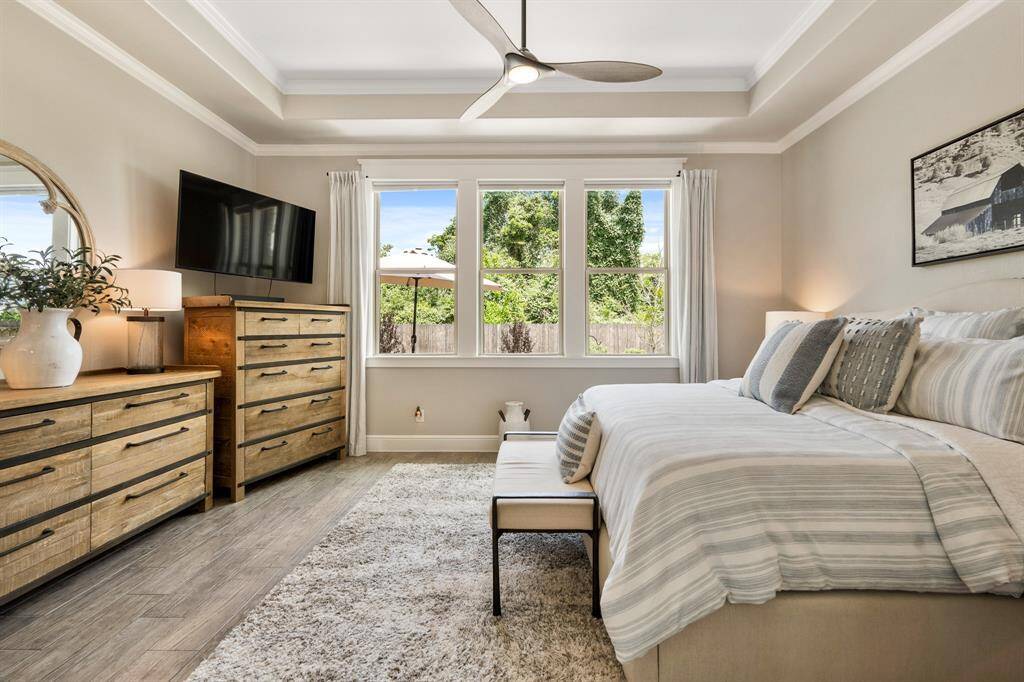 Three fully cased windows usher in sunlight while also offering up lush green views. Curling up with a good book in front of these windows would be a perfect way to end the day!