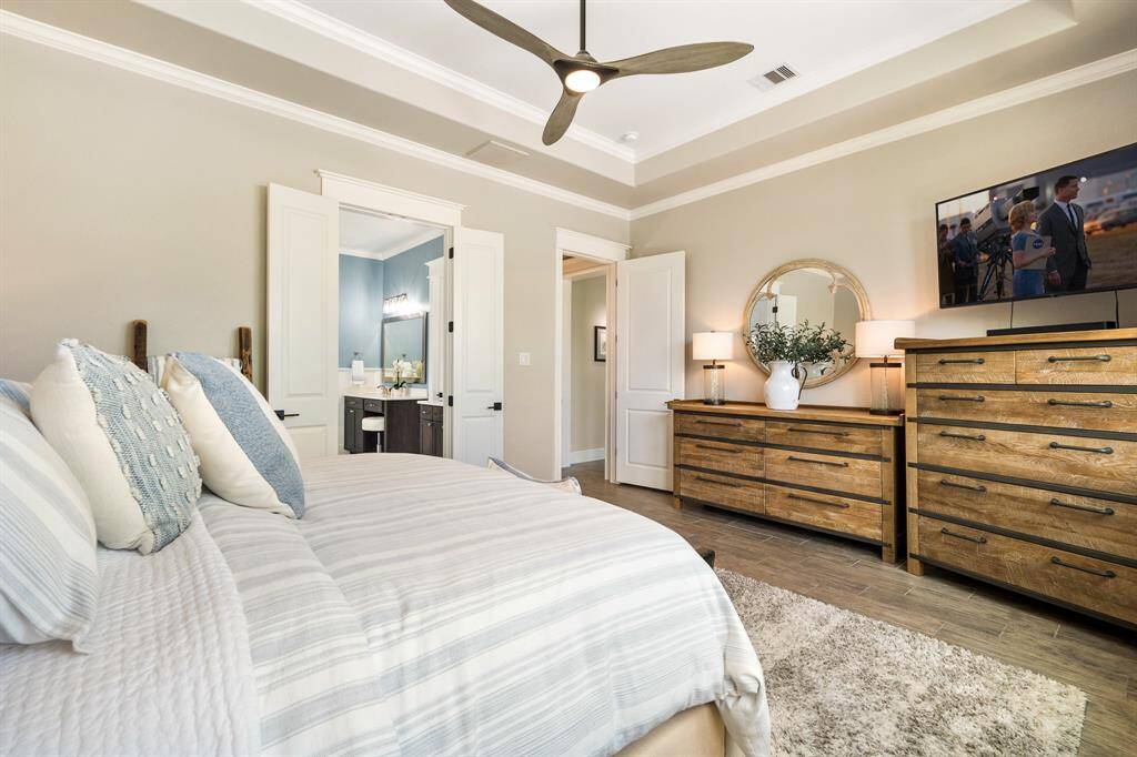 This angle showcases the Primary Retreats location, tucked off the end of a short hallway just beyond the Living Room.  The room is spacious and can easily accommodate additional pieces like a dresser, armoire, or small desk.