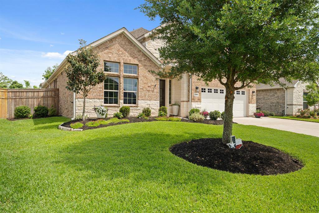 Guests will traverse the colorful front walkway surrounded by low maintenance, colorful flowers and shrubs. The extended concrete driveway offers plenty of extra parking, and the oversized garage features sleek epoxy flooring for a polished, finished look.