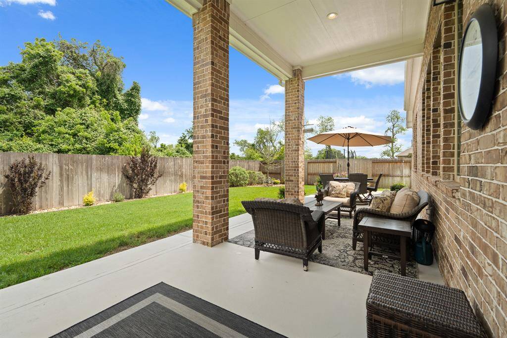 This covered Back Porch is ready to welcome you and a refreshing glass of iced tea! Stay dry and out of the sun while relaxing outdoors. Equipped with recessed lighting, brick pillars, and a gas grill hookup, this is the ideal spot to entertain all year round.