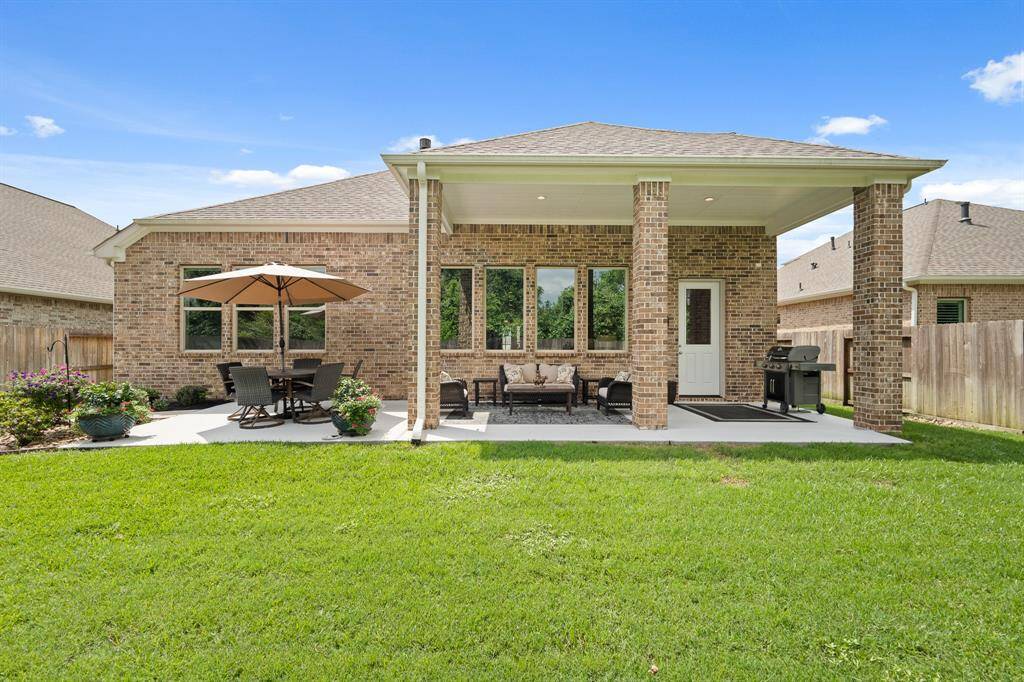 This large Back Patio offers both covered and uncovered options, making it useable no matter what the season. This setup accommodates both an outdoor dining experience, as well as a cozy outdoor seating option.