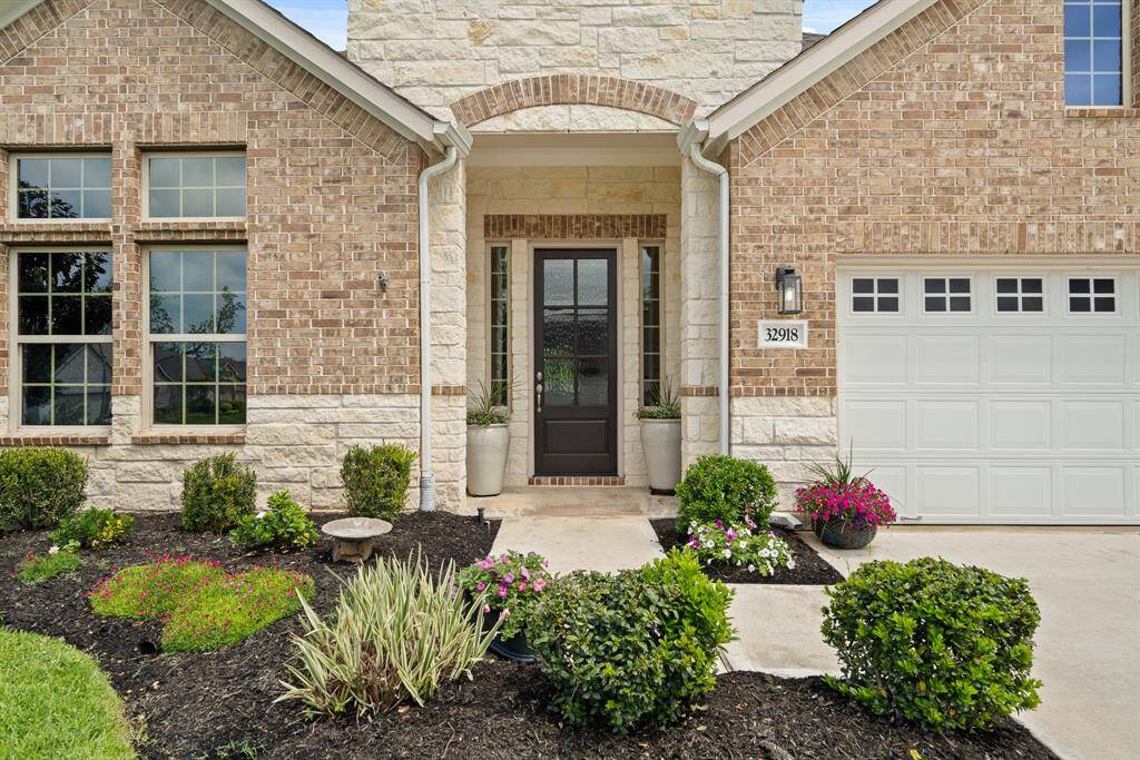 This charming, French country inspired glass plated front door is flanked with sidelights and accentuated by the brick header above. The Front Porch is large enough to display two large flowerpots, adding a little pop of greenery and a whole lot of southern charm!