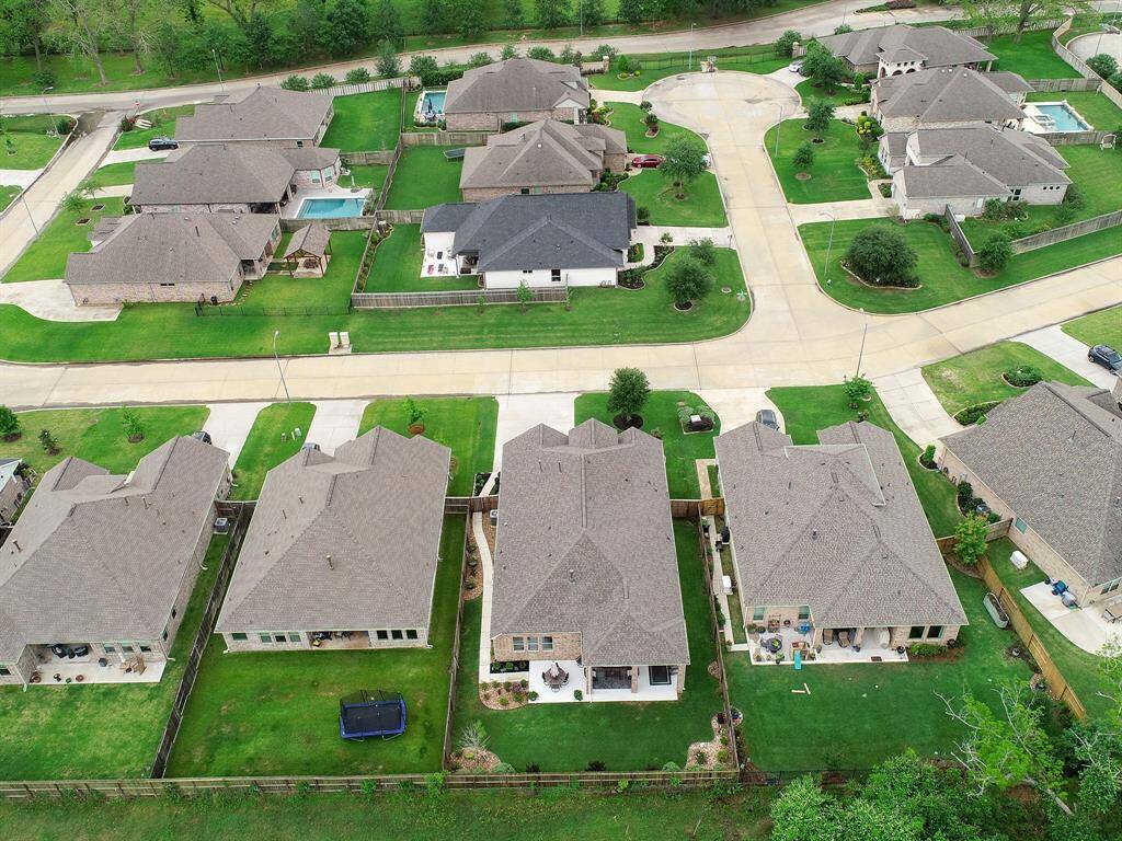 This bird’s eye view highlights the home’s prime location on a quiet street, within a highly sought-after, 24-hour, man-gated community. The neighborhood pickleball courts, playground, and basketball court are walking distance from the home.
