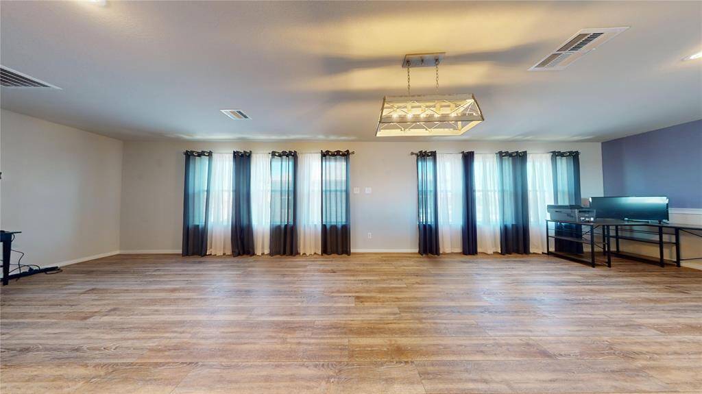 Expansive loft with abundant natural light and elegant wood flooring, perfect for versatile living and entertaining.