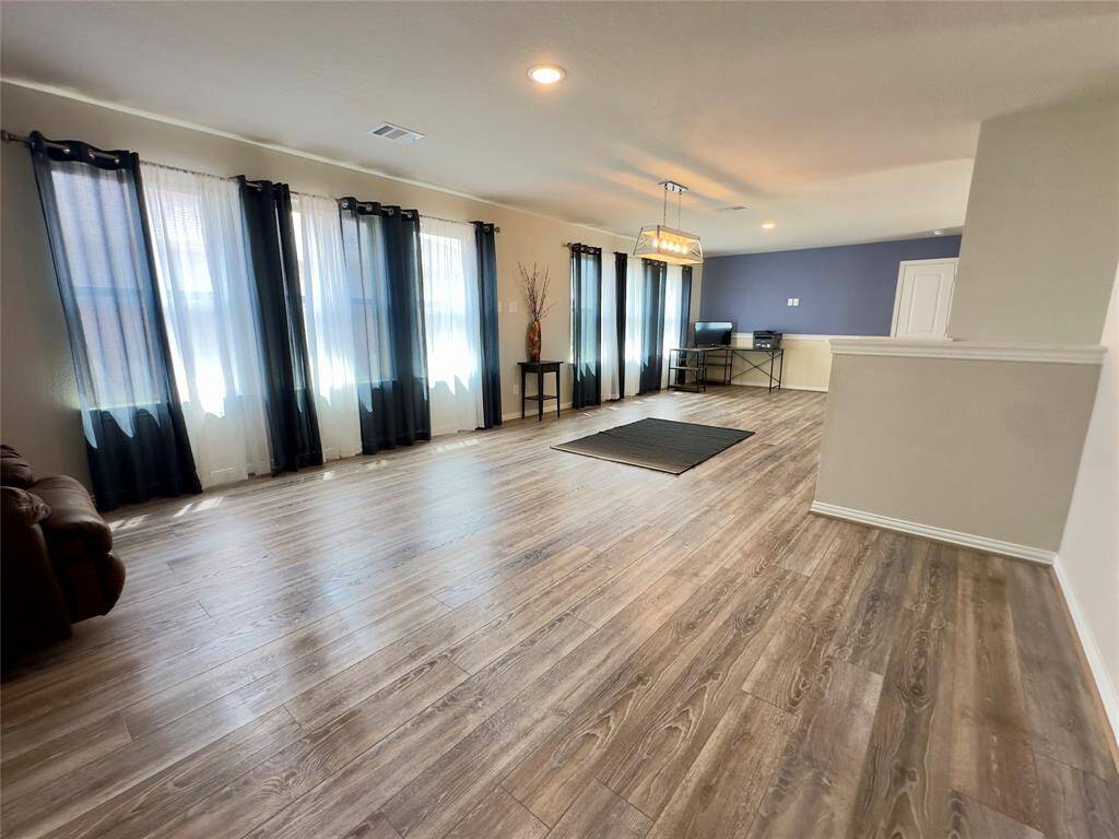 Spacious loft view from the bedroom hallway.