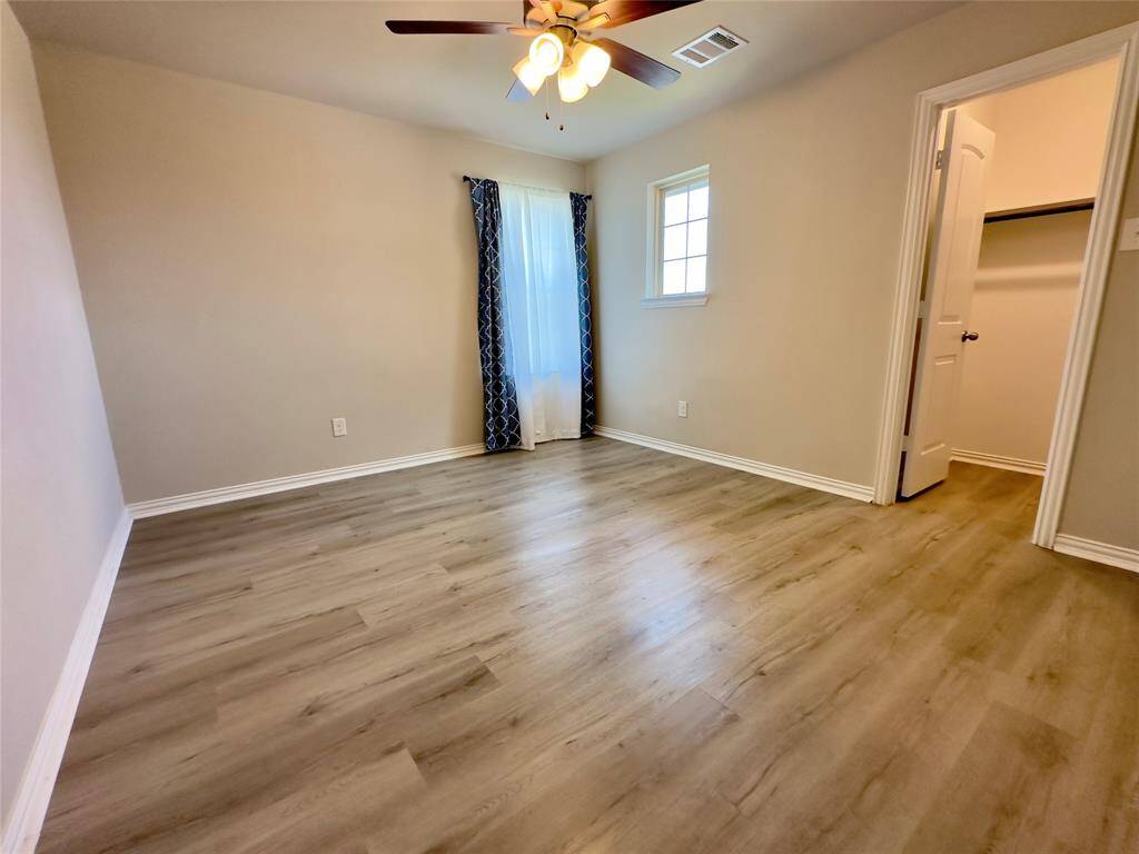 Upstairs guest bedroom with a spacious walk-in closet.