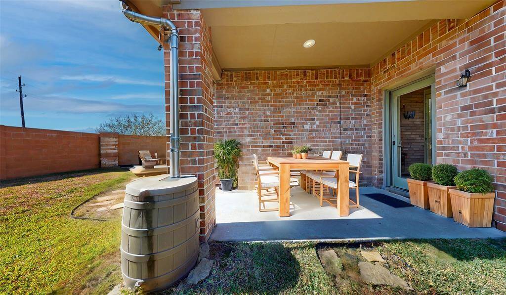 Inviting covered patio, beautifully staged for relaxation and outdoor dining.