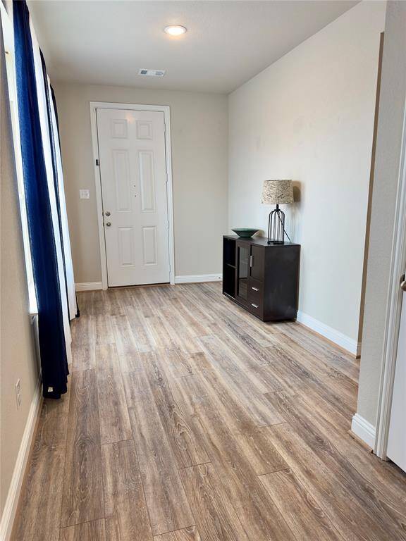 Welcome home to a bright, inviting foyer featuring elegant flooring and ample natural light—a perfect first impression.