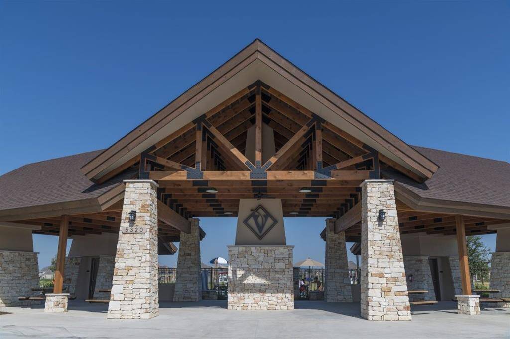 Enjoy the perfect gathering spot at this stunning community pavilion, featuring beautiful stonework and ample space for social events.