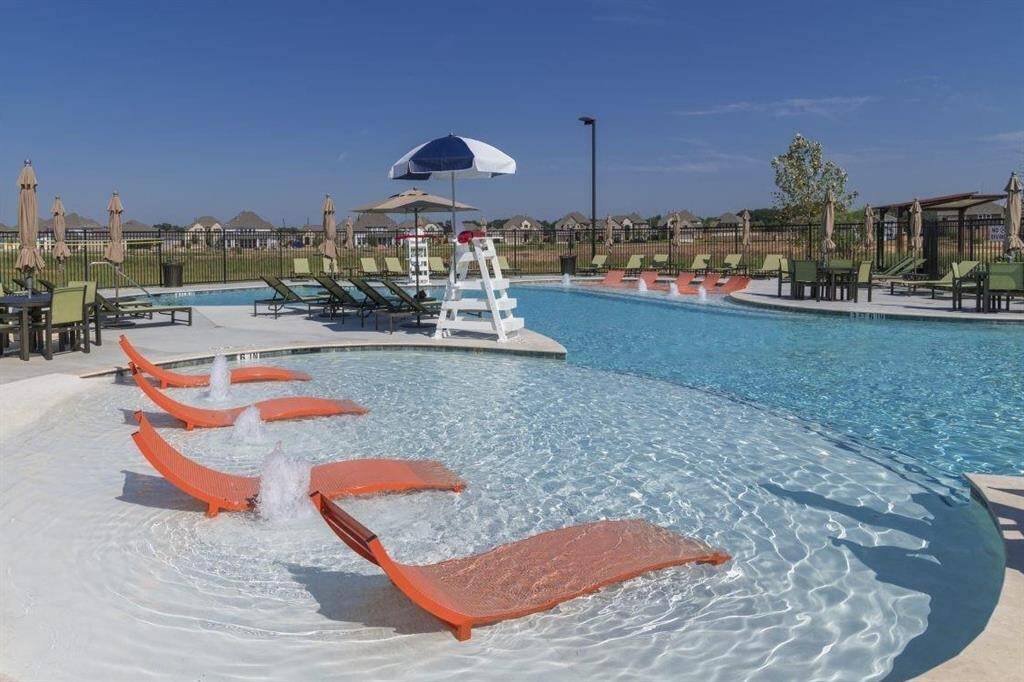 Luxurious community pool with lounge chairs, perfect for relaxation and social gatherings.
