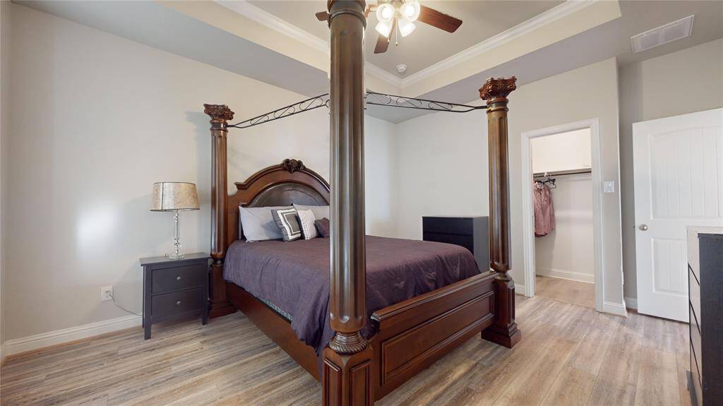 Luxurious primary bedroom featuring elegant tray ceilings.