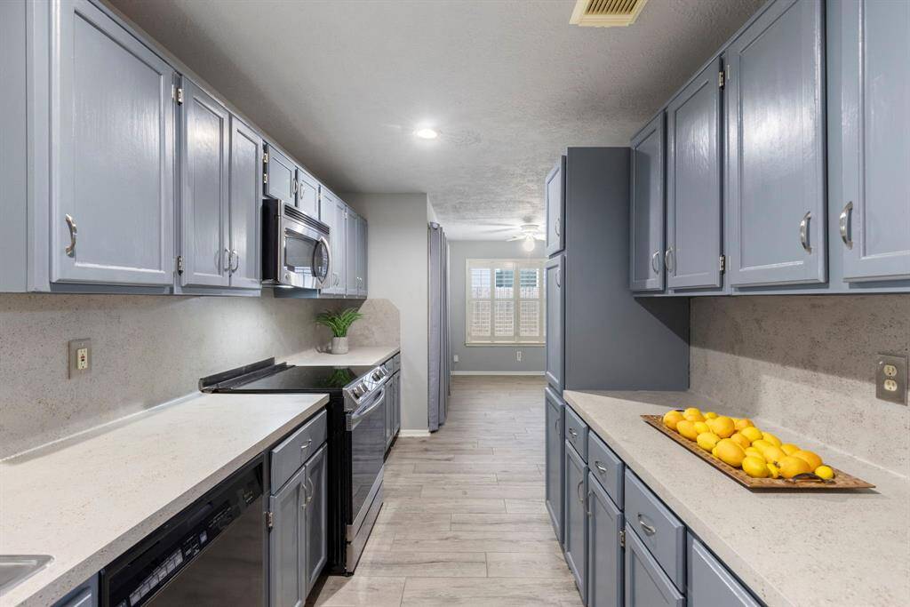 Stylish kitchen with beautiful gray cabinets and a spacious breakfast area ideal for casual dining.