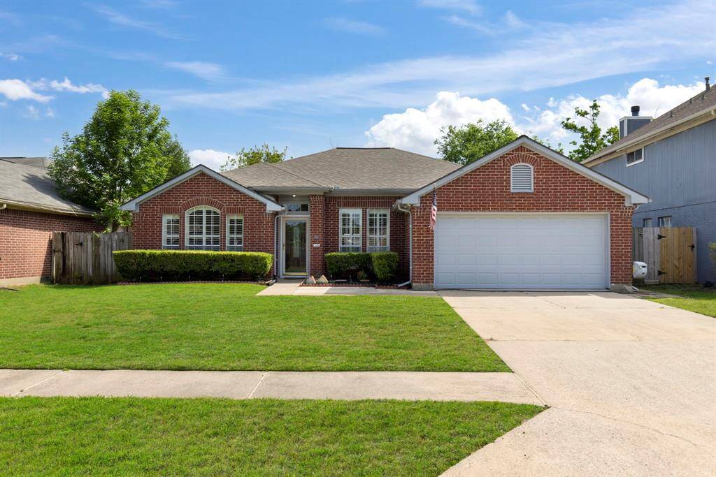 Nicely landscaped front yard with lush greenery and a spacious lawn.