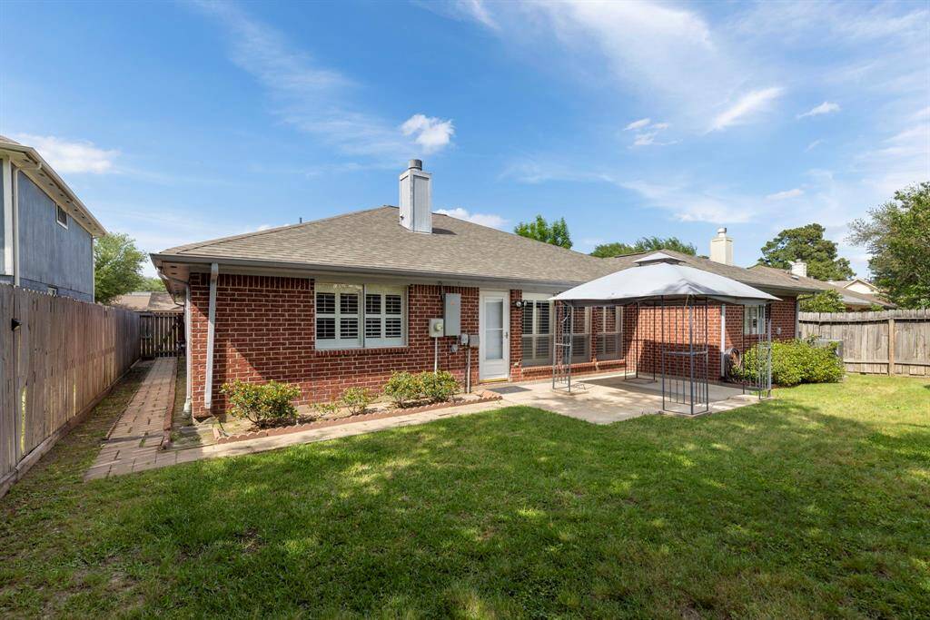 Step out back to enjoy the expansive backyard while relaxing under the elegant gazebo.