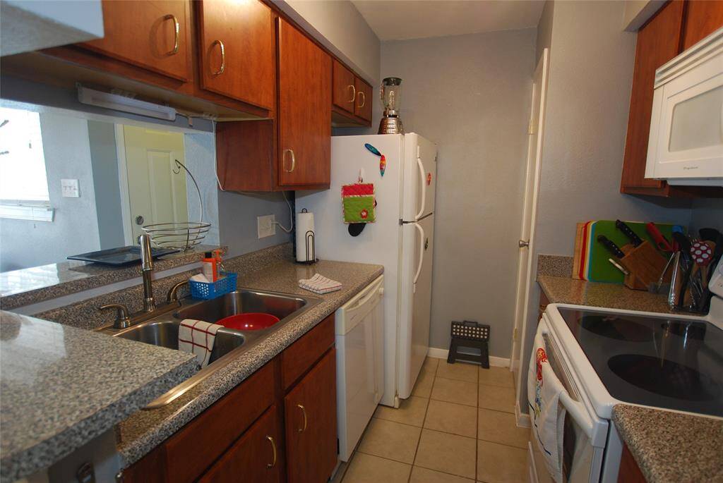 Plenty of storage in this galley kitchen with pantry.