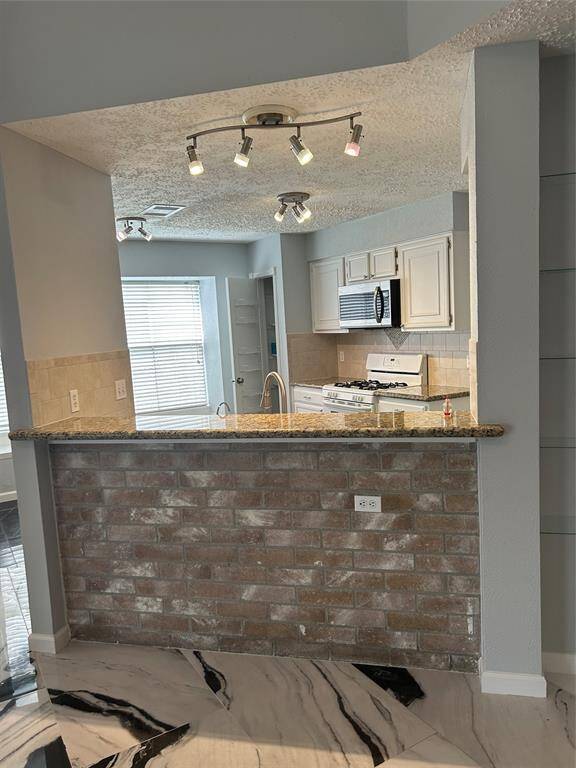 Breakfast bar looking into kitchen and Breakfast area