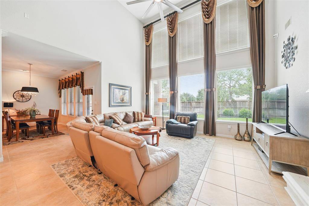 The high ceiling living room provides good light, view and sense of space
