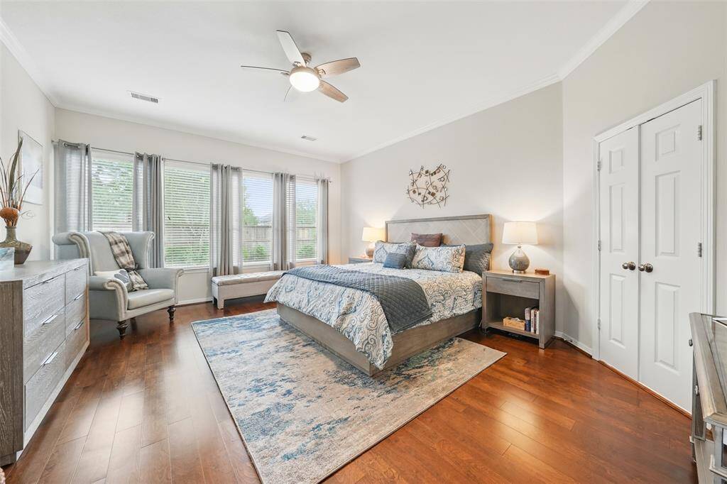 The oversized master bedroom with a full wall of windows provides great light and views